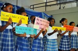 Claude O. Markoe second-graders hold up facts about Rothchild Francis during their performance.